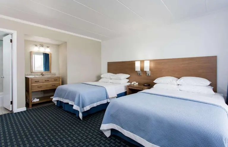 Two double beds in a street-view room at Mariner Inn and Suites