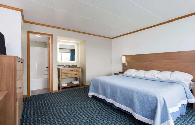 King bed in an ocean-view room at Mariner Inn and Suites
