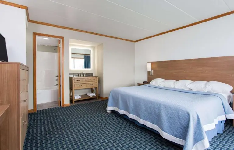 King bed in a street-view room at Mariner Inn and Suites