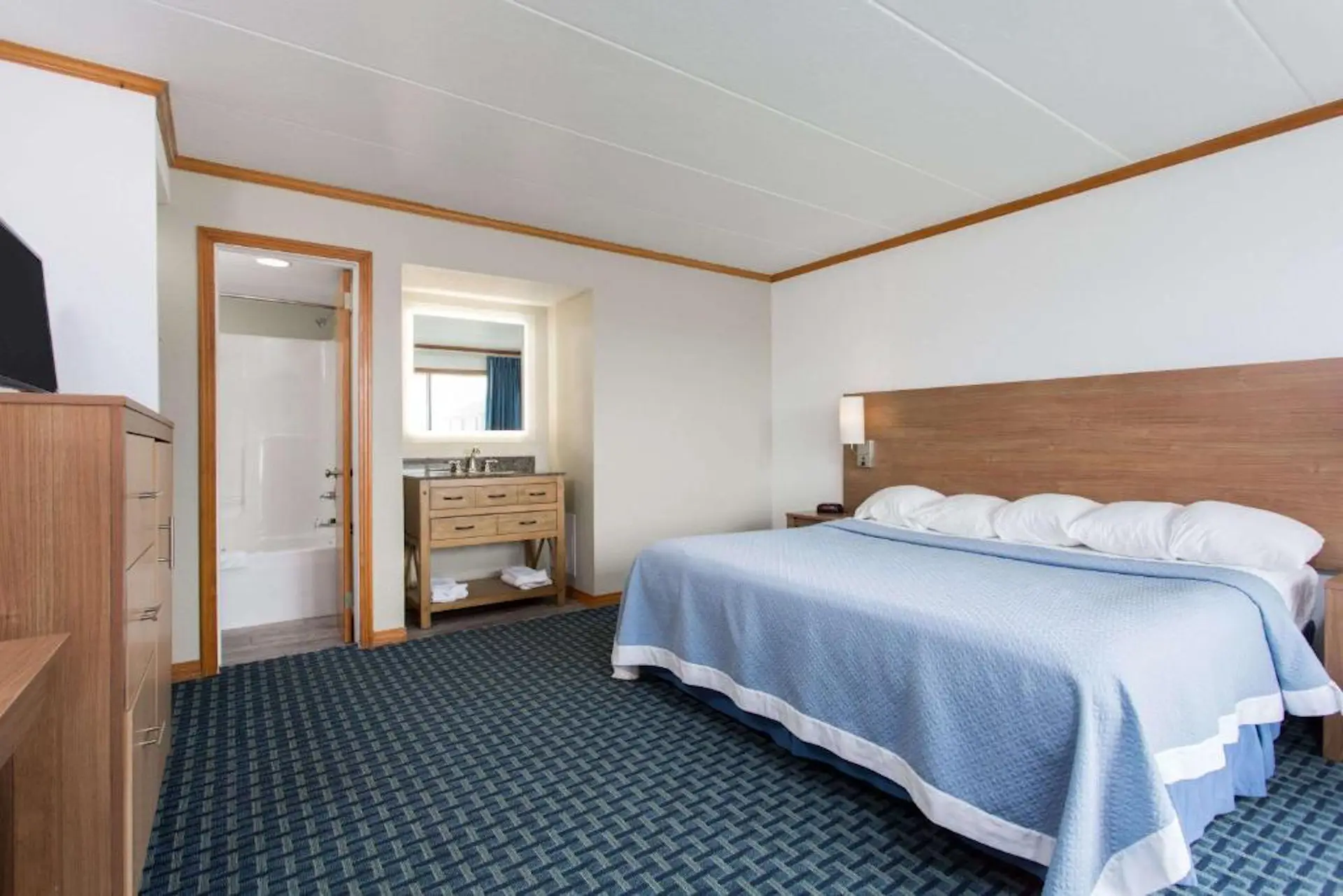King bed in an ocean-view suite at Mariner Inn and Suites