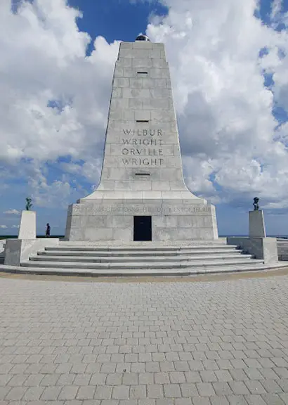 The granite Wright Brothers National Memorial monument on Big Kill Devil Hill, inscribed with the names Wilbur Wright and Orville Wright
